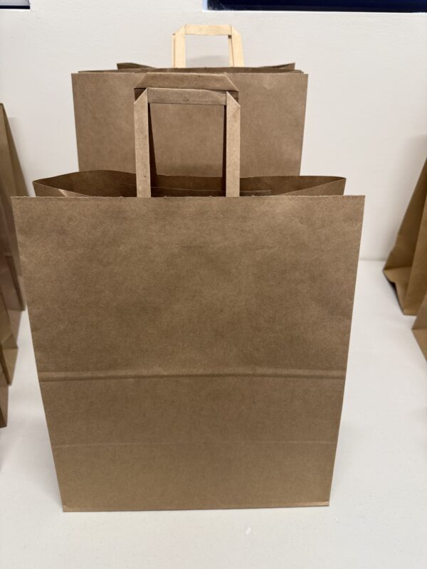 A brown paper bag sitting on top of the floor.