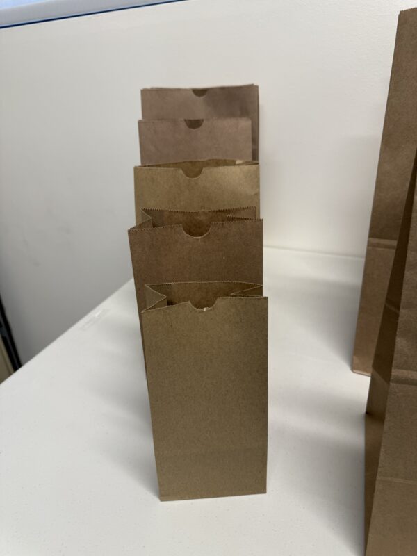 A stack of brown paper bags on top of each other.