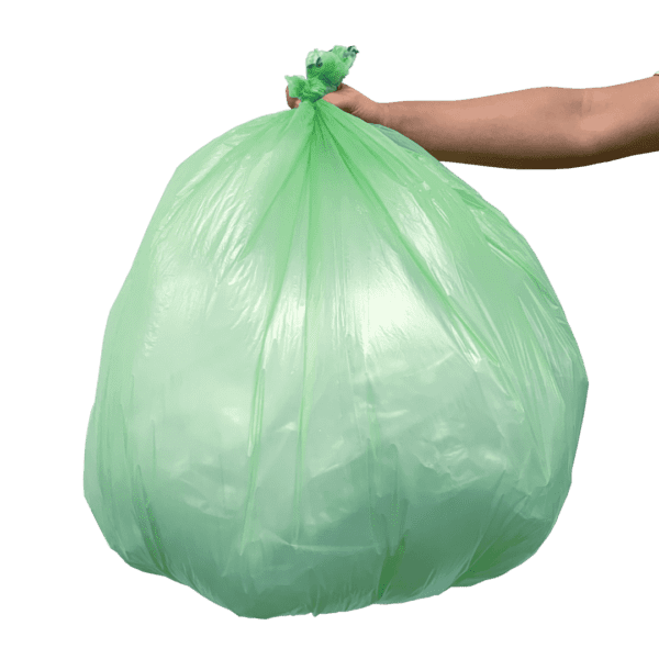 A hand holding onto a green bag of garbage.