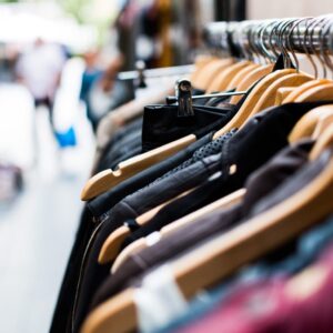 A row of clothes hanging on a rack.