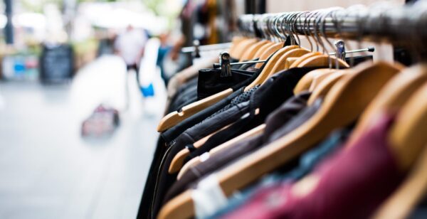 A row of clothes hanging on a rack.