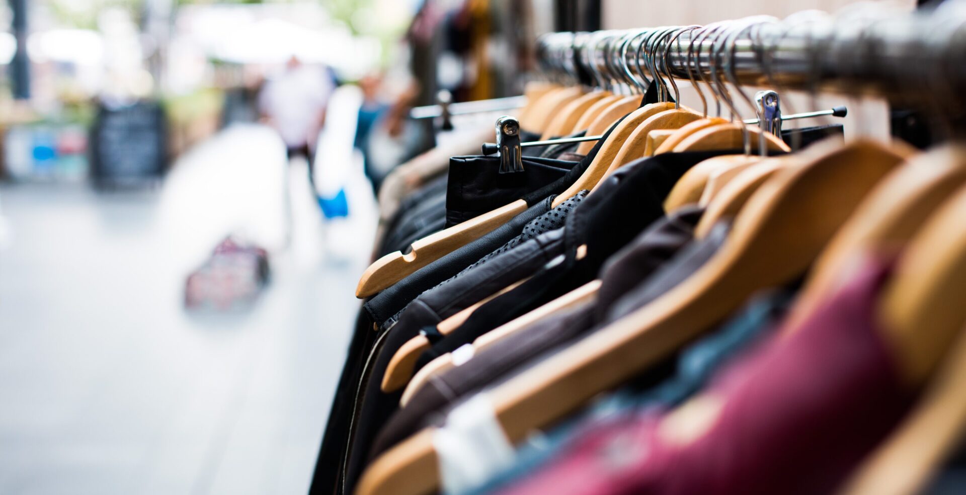 A row of clothes hanging on a rack.