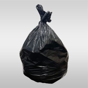 A black bag of garbage sitting on top of a floor.