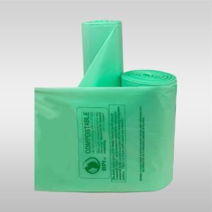 A green bag of garbage sitting on top of the ground.