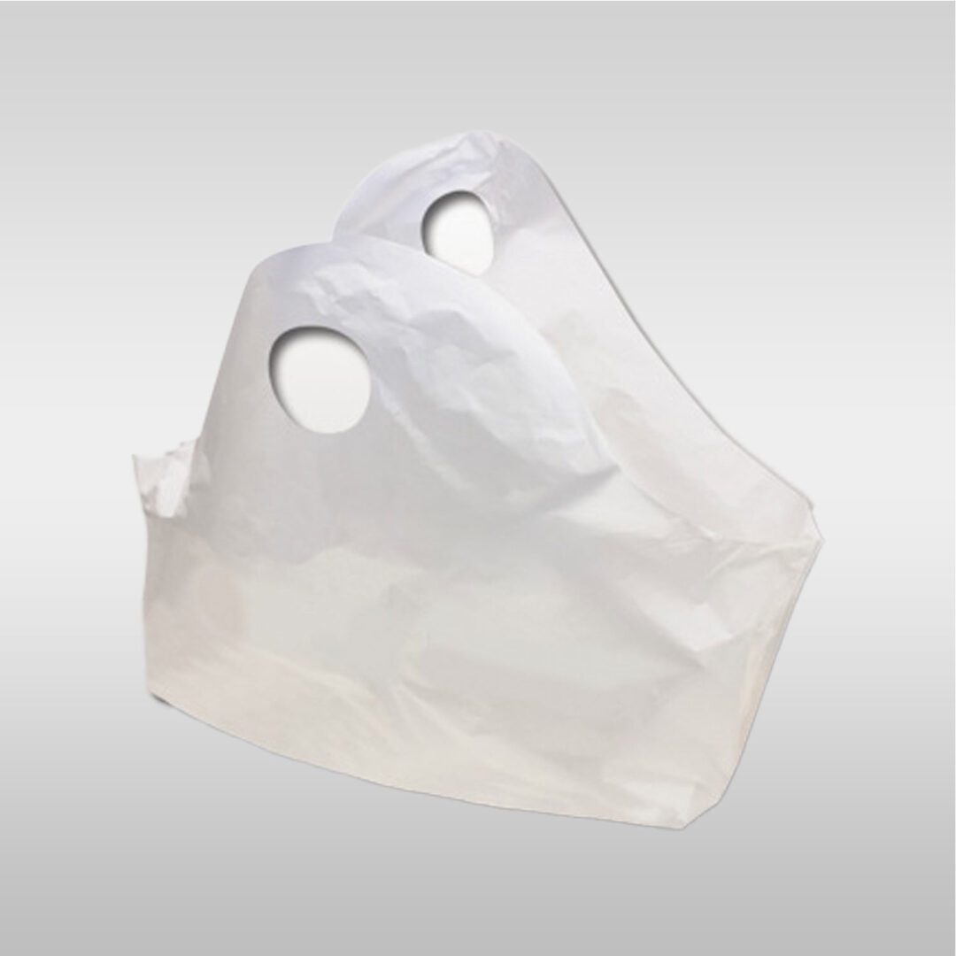 A white bag is sitting on top of the ground.
